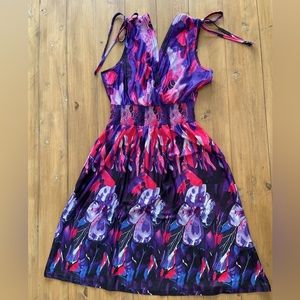 Women’s pink/purple/black dress. Elastic waist, bow-ties at shoulder.